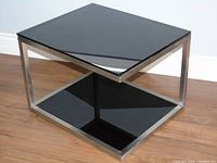 Overall view of chrome frame end table with smoked glass top and base