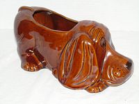 left side view of brown glazed ceramic basset hound planter