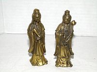 Front view of both brass Guan Yin figurines