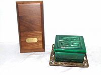 walnut box beside green ceramic box on stand