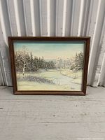 front view of framed winter landscape painting showing scene and frame