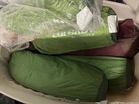 Multiple green Eureka El Capitan 4 tents in bin with maroon bag