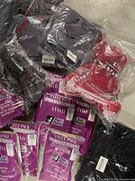 Multiple pantyhose packs, grey tops, red bear, black garment