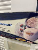 Front of original Panasonic SR-NA18 box showing product image and specifications