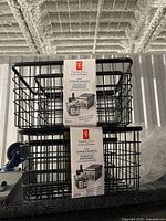 two unopened retail packs of President's Choice wire storage baskets stacked