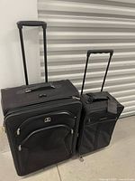 Travelpro large suitcase and Samsonite carry-on side by side