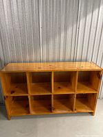 Front view of wooden shelf showing 8 cubbies