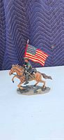 Left-front view of figurine showing soldier, horse, and flag