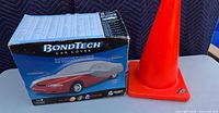 BondTech car cover box beside orange traffic cone