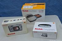 Front view of three Kodak EasyShare boxes: printer dock, camera dock II, DX4330 camera