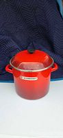 Front view of Le Creuset red tall stockpot with lid