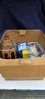 Overall view of medium box showing lantern, boxed SinuPulse, yellow scoop and other contents