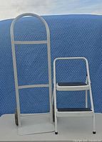 Milwaukee hand truck and Cosco step stool front view