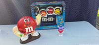 Overall lot showing red dispenser, boxed Millennium 2000 set, small purple figure