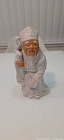 Front view of glazed porcelain Shou deity figurine