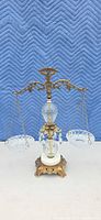 Full view of ornate decorative balance scale with glass bowls