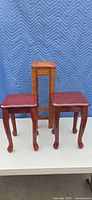 Front view of two low stools and tall stand