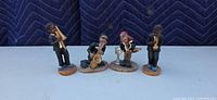 Front view of all four jazz musician figurines