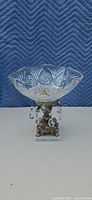 Full view of crystal compote showing glass bowl, metal pedestal, prisms, marble base