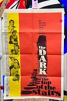 Full view of folded one-sheet poster pinned to board