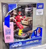 Front view of boxed Sheldon Cooper Movie Maniacs figure showing limited edition sticker and contents