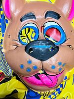 Front view of mask showing facial details and wear