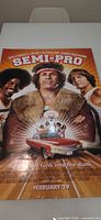 Full view of Semi-Pro poster on table