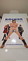 Full view of The Rocker movie poster on table