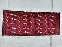 Full view of red Torkaman rug showing size and pattern