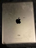 Rear view of iPad showing Apple logo, scuffs
