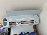 Cricut Maker 3 top view with lid open showing tool carriage