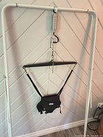 Full view of jumper suspended showing spring, chain, crossbar and seat