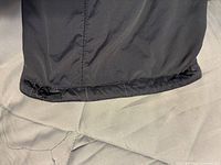 Close view of adjustable draw-cord cuff at pant leg