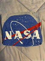 Folded NASA t-shirt showing front logo