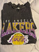 Folded T-shirt showing front graphic and team logo