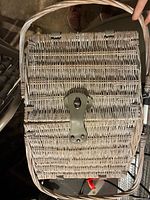 Closed grey wicker picnic basket showing shape, weave and handle