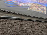 Black binder closed showing thickness of card pages