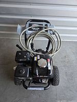 Front view of Simpson gas pressure washer showing engine, frame and hose