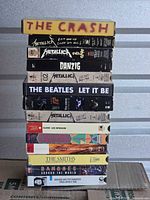 Full stack showing spines of all fourteen VHS tapes