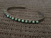 Full view of sterling silver cuff showing entire row of turquoise stones