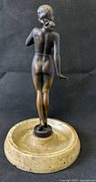 Rear view of bronze nude on marble base