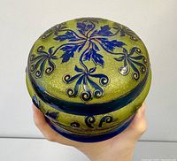 Top view of olive glass lidded box with cobalt blue floral cameo decoration
