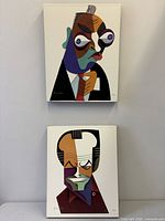 Front view of both canvases hanging, showing full artworks