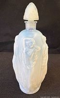 Front view of Sabino opalescent perfume bottle showing nude figure relief and stopper