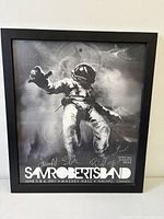 Framed Sam Roberts Band concert poster front view, showing astronaut artwork and signatures