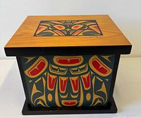 Front view of painted wooden lidded box with signed lid