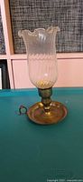 Brass chamberstick with glass shade assembled