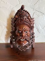 Front view of carved rosewood emperor mask