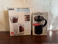 Front view of boxed Braun Coffee/Espresso Mill and Bodum Coffee Press