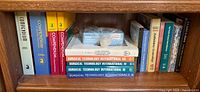 Shelf with multiple medical reference books and plastic bag containing rock specimen
